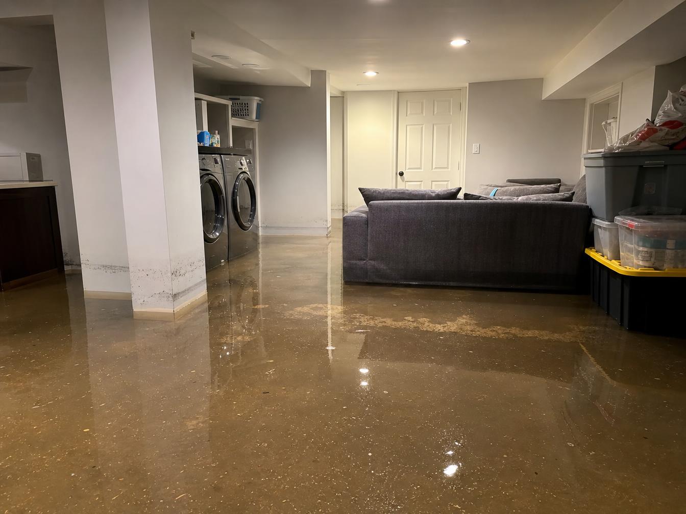 Flooded modern basement interior illustrating the risk of sewer backup damage